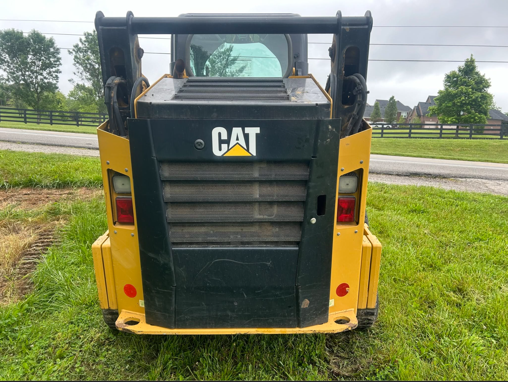 Rear view of yellow tracked loader