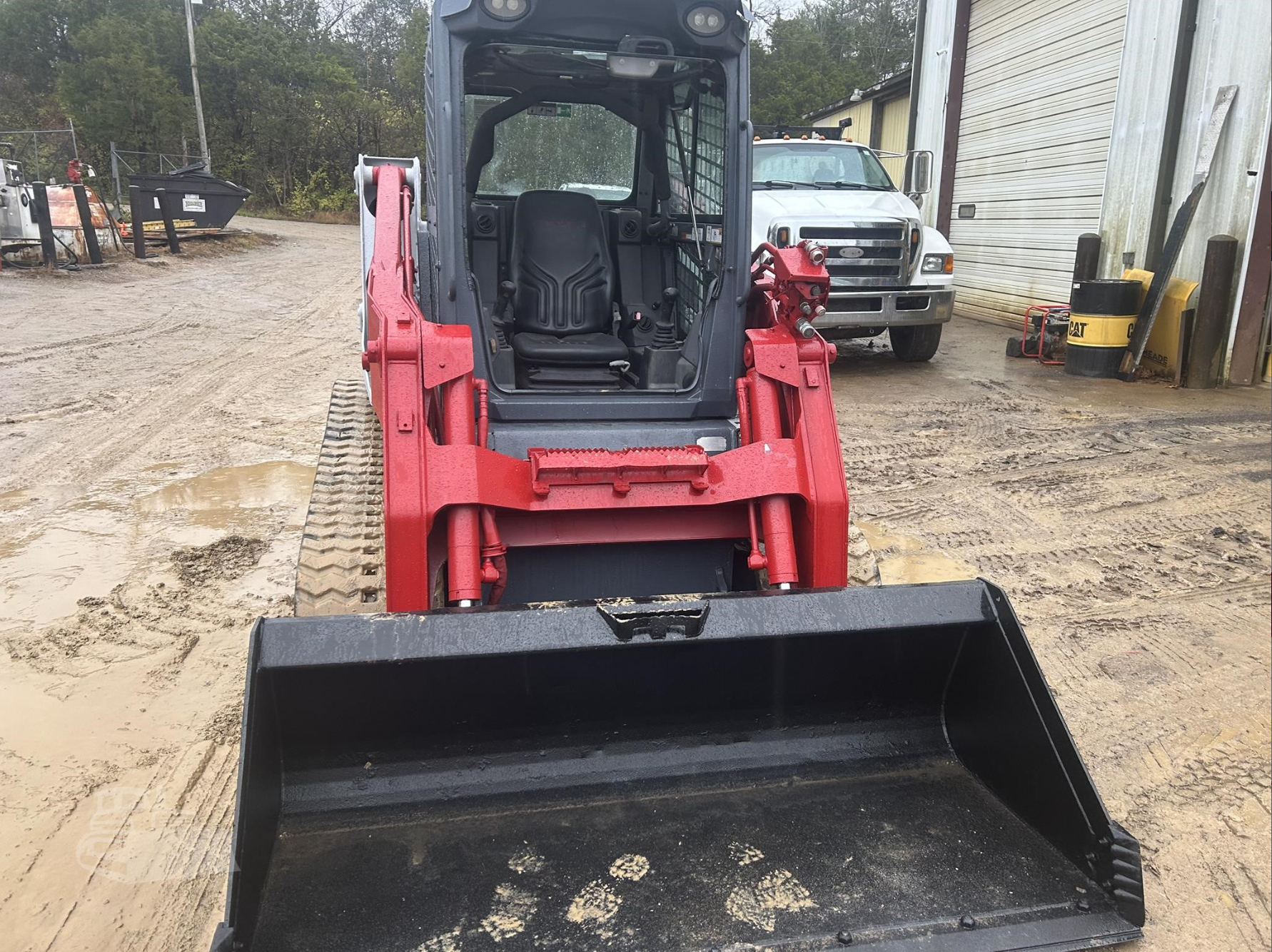 Red compact tracked loader front view