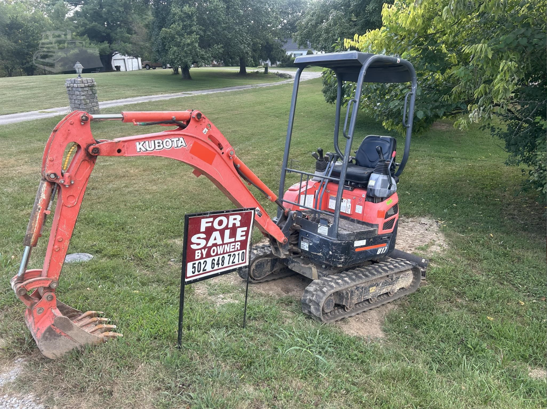 Red mini excavator outdoors